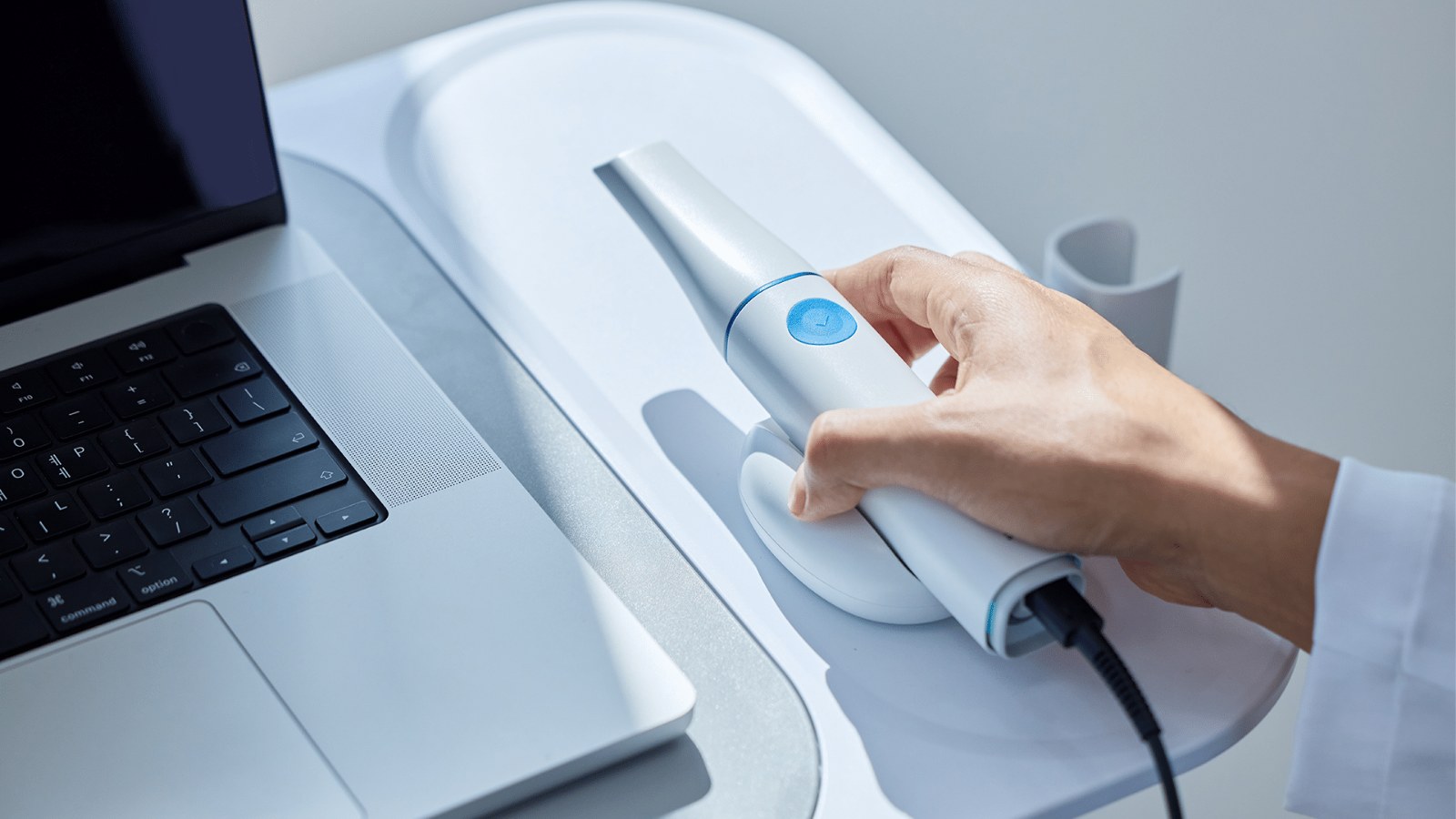 Medit i900 Classic intraoral scanner in its cradle next to a laptop